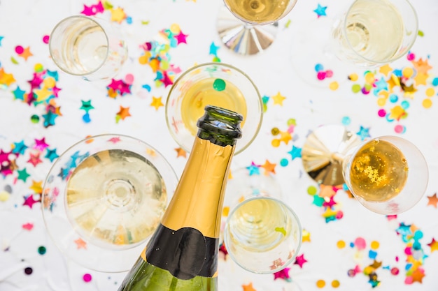 Champagne pouring in glass on table 