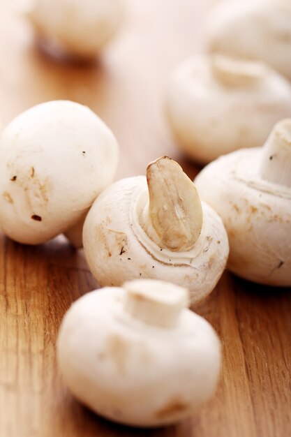 Champignons on wooden surface