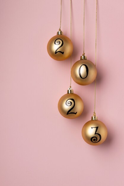 Change of year concept with golden globes top view