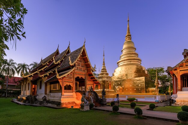 황혼 또는 밤 하늘에 별이 있는 치앙마이 Wat Phra Singh Woramahawihan의 예배당과 황금 탑