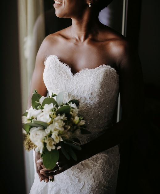 Free photo charming african american bride smiles standing before the windo