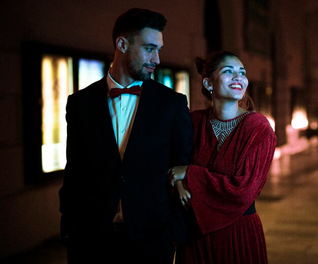 Charming attractive smiling woman walking with young man on street