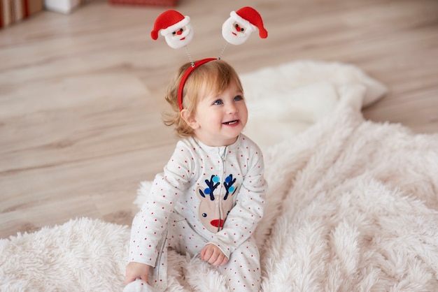 Charming baby in Christmas morning