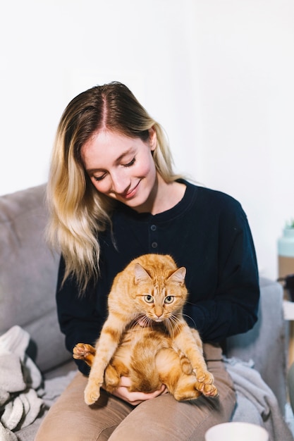 Free photo charming blonde with gorgeous ginger cat