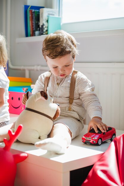 Charming boy playing in kindergarten