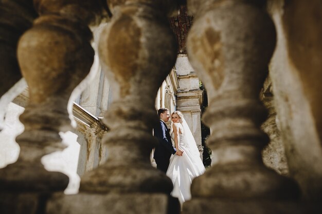 The charming brides standing near an ancient building