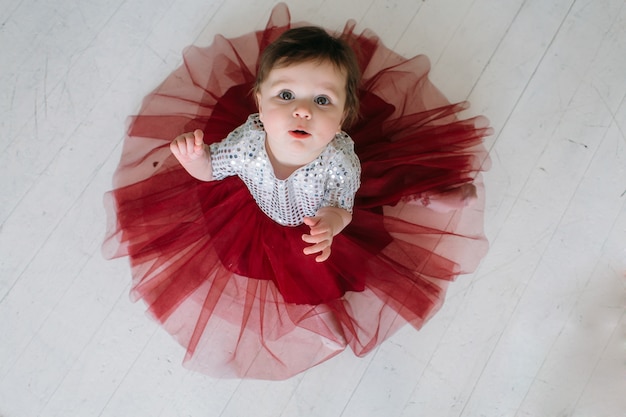 The charming child sitting on the floor