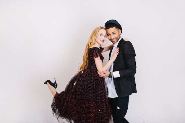 Charming couple in love hugging. Luxury evening clothes, celebrating party, having fun, attractive young woman with long blonde hair, lovers, together.