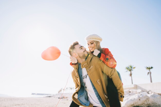 Charming couple in love with red balloon