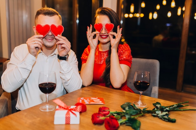 Charming couple posing playfully in cafe