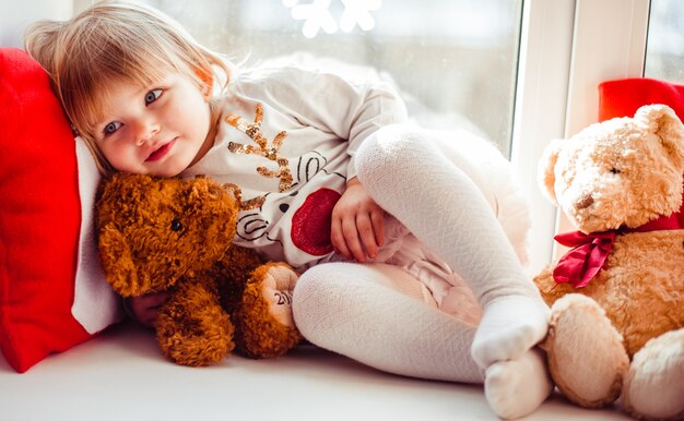 The charming daughter lies on the window-sill