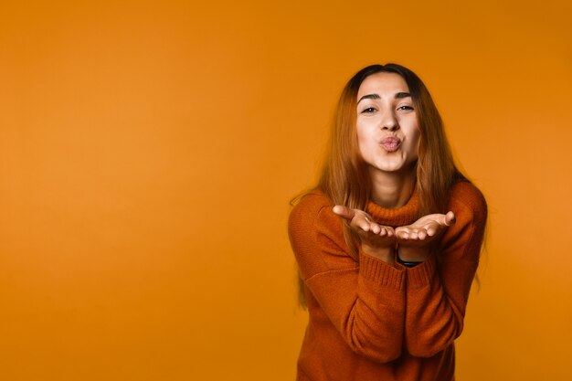 Charming girl blowing air kiss