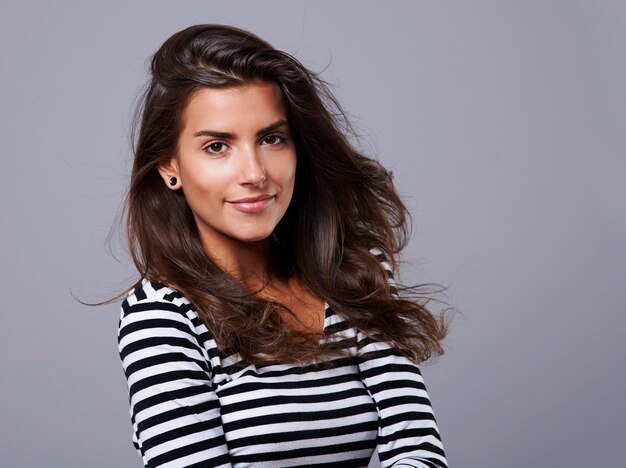 Charming girl dressed in striped blouse