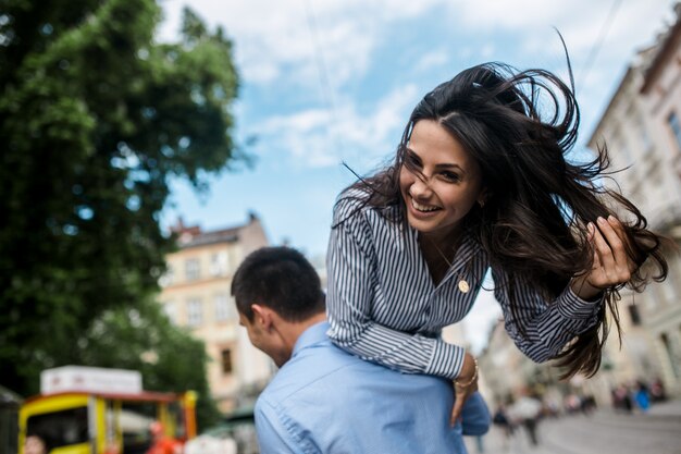 Charming girl on male shoulders