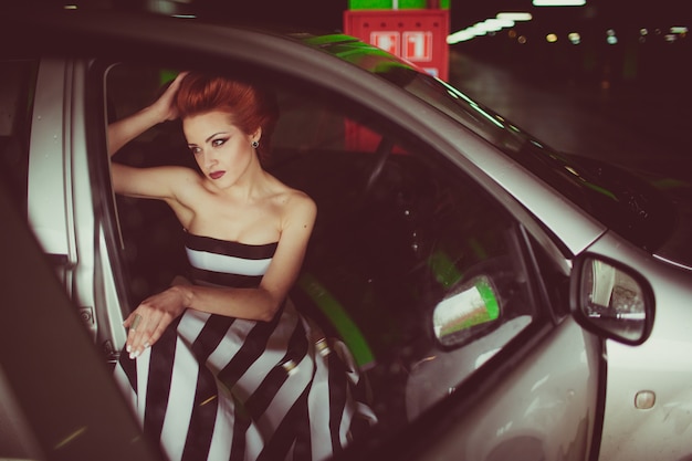 The charming girl sitting in the car