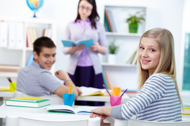 Charming girl sitting in class