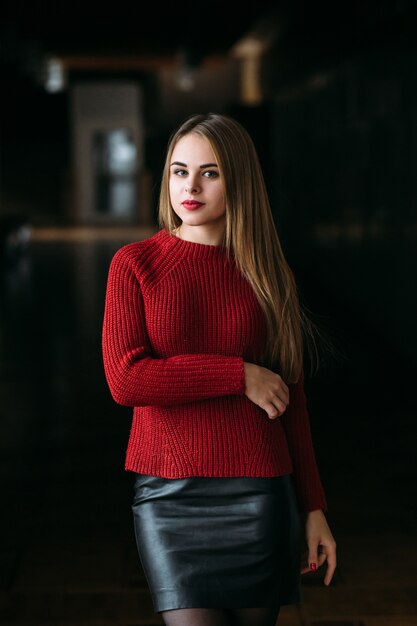 The charming girl stands in the corridor