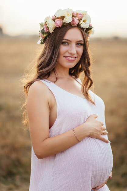 The charming girl stands in the field