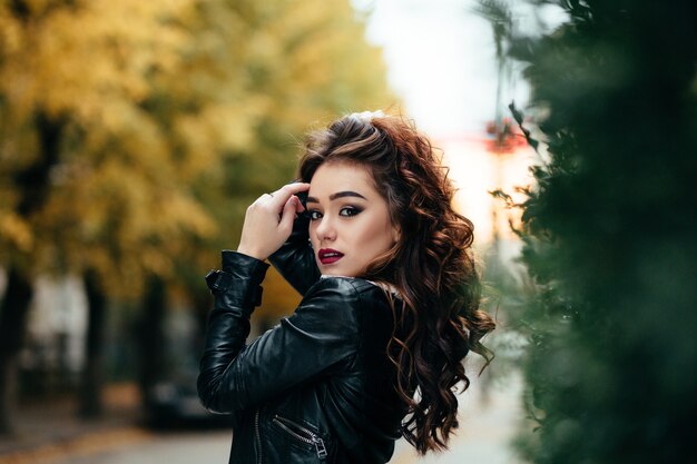 The charming girl stands on the street