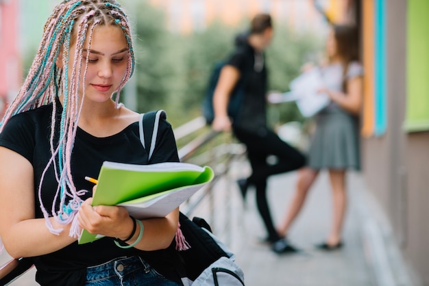 Ragazza affascinante che prende appunti nel libro