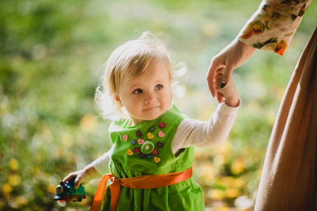 Free photo the charming girl with mother walking along park