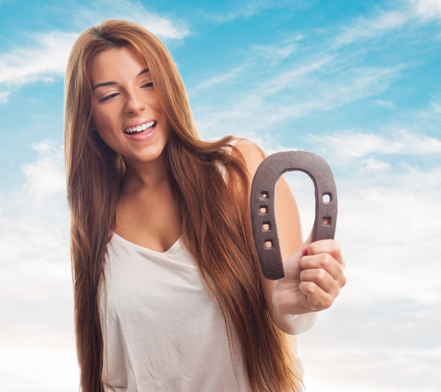 Charming girl with rusty horseshoe