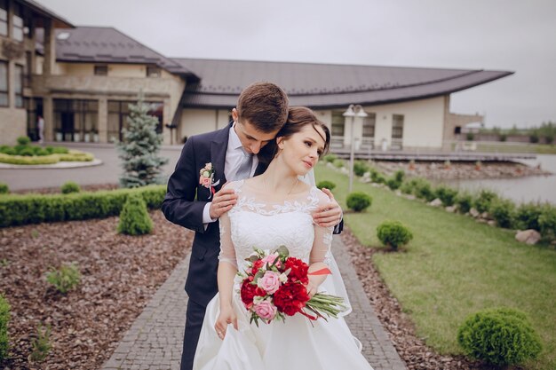 Charming groom hugging the bride