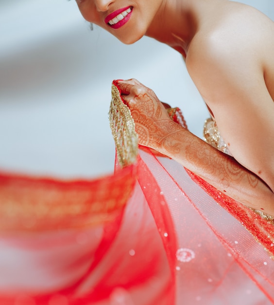 Free photo charming hindu bride holds red cloth in her hand