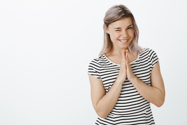 Charming intrigued blonde girl posing in the studio