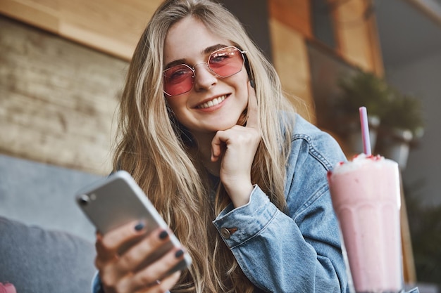 Free photo charming intrigued urban female in stylish denim jacket leaning