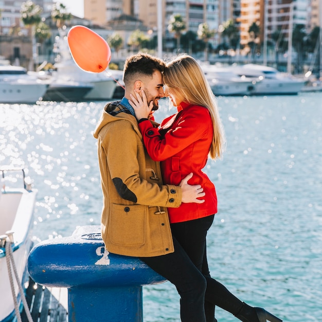 Charming kissing people on seafront