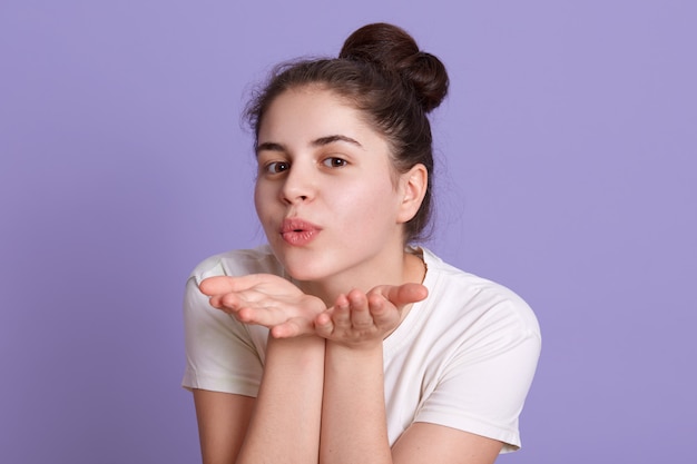 Charming lady making air kiss gesture