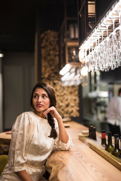 Charming lady sitting at bar counter