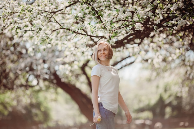 The charming lady stands in the park