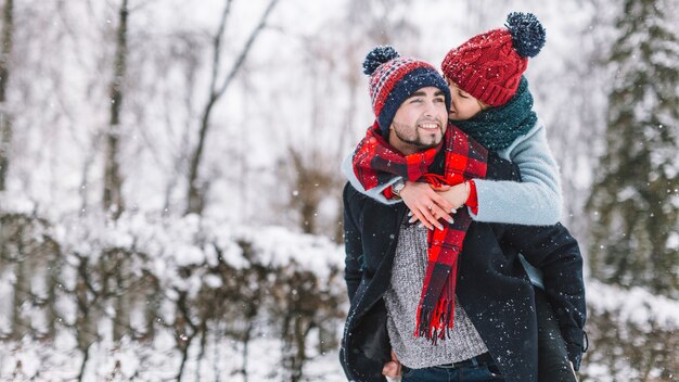 Charming loving couple in snowy forest