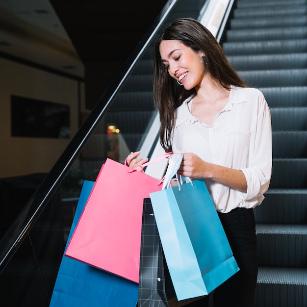 Free photo charming model exploring shopping bags