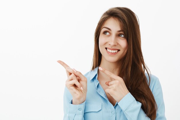 Charming optimistic brunette businesswoman posing in the studio