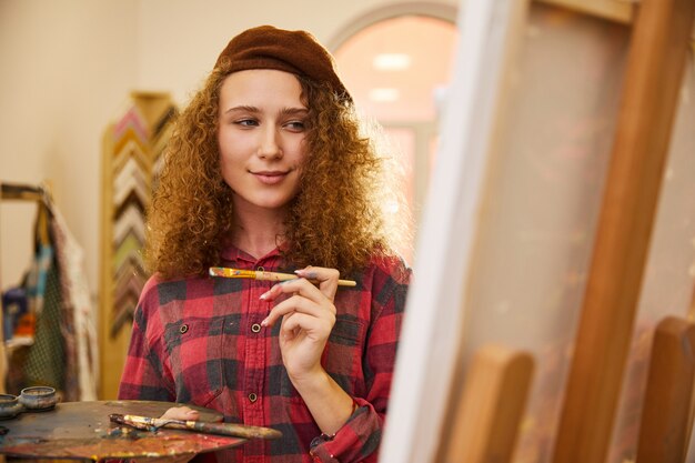 Charming redhead artist draws a picture