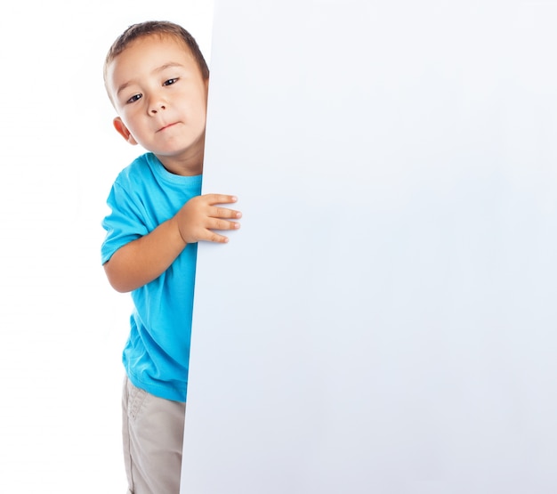 Charming schoolboy with a blank sign