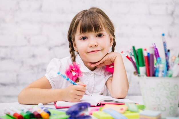 Charming schoolgirl posing at camera