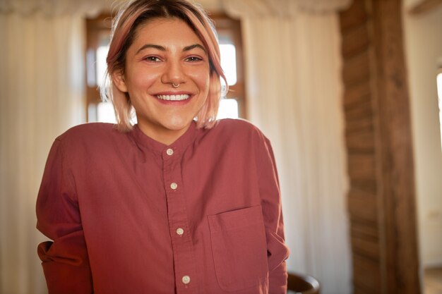 Charming student girl in good mood relaxing at home