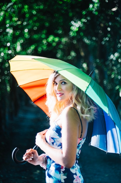 Free photo charming stylish model with colorful umbrella