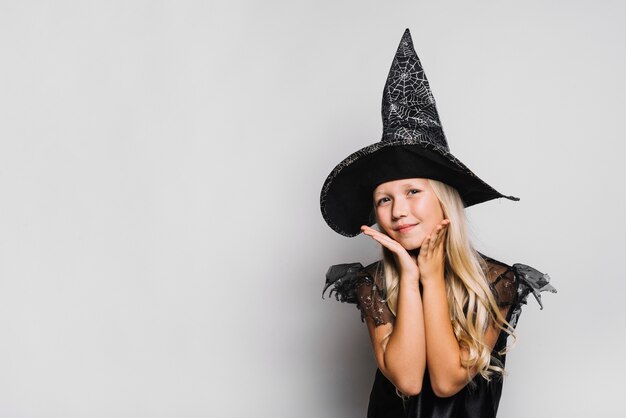 Charming witch looking at camera