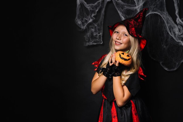 Charming witch with pumpkin