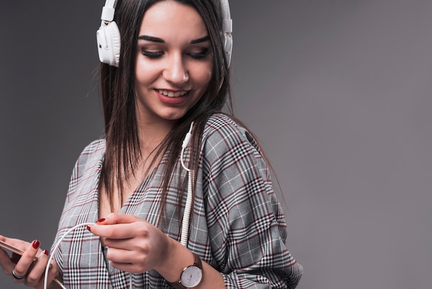 Charming woman enjoying music]