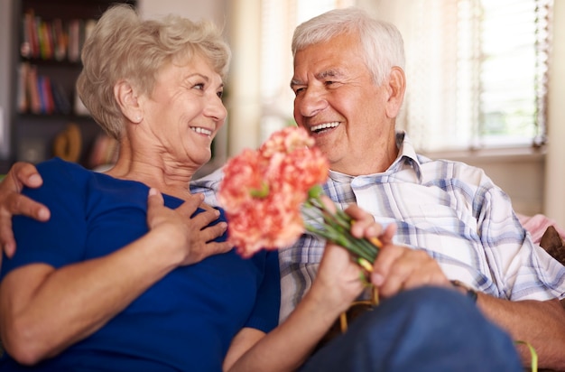 Free photo charming woman is given a bunch of flowers