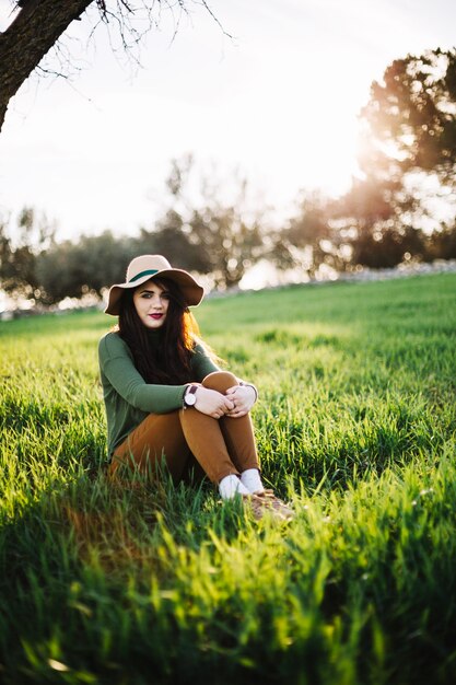 Charming woman sitting on lawn