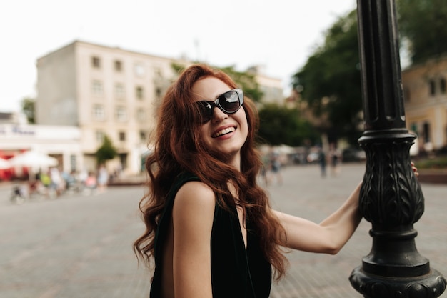 Charming woman in sunglasses smiling