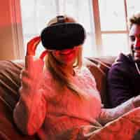 Free photo charming woman in vr glasses near boyfriend