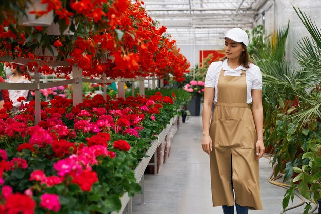Charming woman walking in large modern greenhouse
